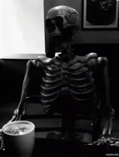Skeleton drinking coffee