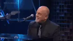Billy Joel laughing at piano