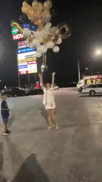 Woman releases balloons that float away