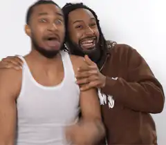 Two men pointing at camera laughing