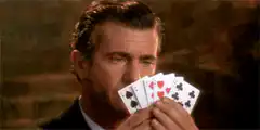Mel Gibson looking at cards