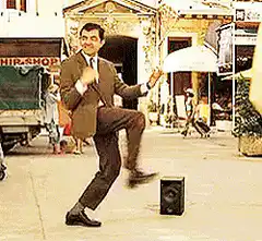Rowan Atkinson dancing in the street