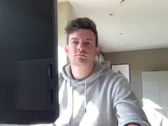 Man in grey hoodie looking at camera