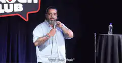 Comedian tapping microphone