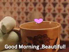 Green monster holding a mug with a heart