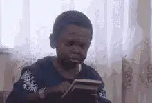 Boy reading book and laughing