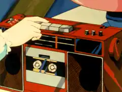Hand inserting cassette into boombox