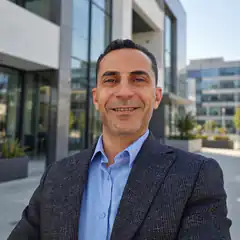Man in suit smiling outside office