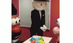Mr. Monopoly dancing with Mr. and Mrs. Monopoly