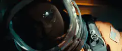 Astronaut removes helmet