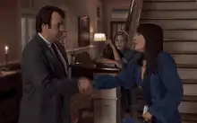 Ron Burgundy shakes a woman's hand