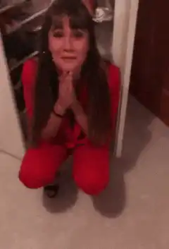 Woman praying in red outfit