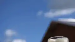 beer mugs clinking against blue sky