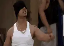 Man in beanie and tank top dancing