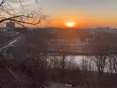 sunset over city river and bridge