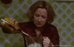 Woman pouring drink with sad face