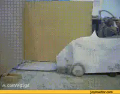 Man in cardboard car pretending to drive