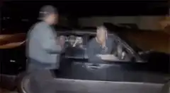 Man dancing in car window