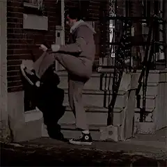 Man kicks brick wall with one leg