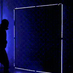 Silhouette walks through glowing blue portal