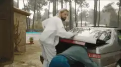Two men loading a piano into a car