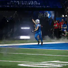 Amon-Ra St. Brown runs onto the field