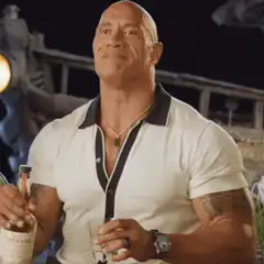 Dwayne Johnson raises a bottle of tequila