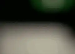 blurry green light and white surface