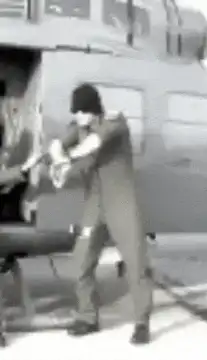 Man dancing in front of helicopter