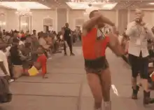 Man in red shirt and leopard shorts dancing