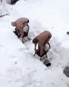 Two men dive into snow