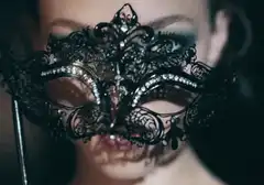 Woman lifting black lace mask
