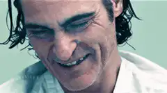 Joaquin Phoenix laughing and smoking