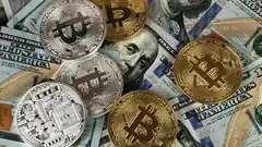 Bitcoin coins on US dollar bills