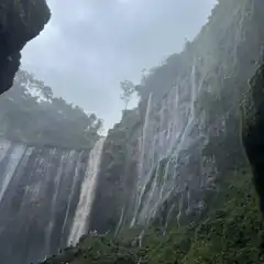 waterfall with people at base