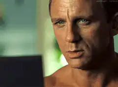 Daniel Craig as James Bond staring at a laptop