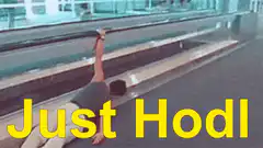 Man hanging from escalator Just Hodl