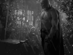 Batman standing in the rain