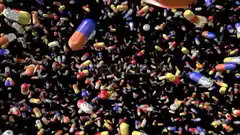 Colorful pills and capsules falling