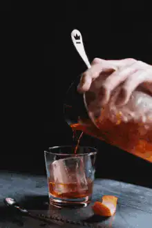 Pouring amber liquid into a glass