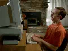 Man typing on old computer