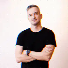 Man with arms crossed and green dots