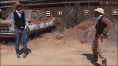 Two cowboys draw guns in a standoff