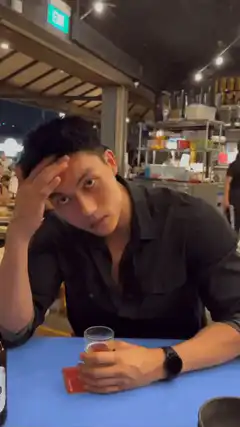 man holding head at bar