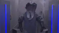Person in hazmat suit in blue light