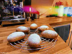 Powdered sugar pastries on cooling rack