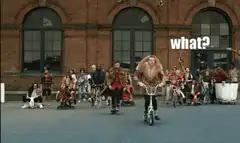 People riding bikes and rollerblades in fur coats