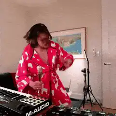 Man in pink robe singing karaoke