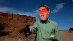 Man with glowing red eyes pointing gun