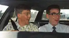 Three nerds laughing in a car